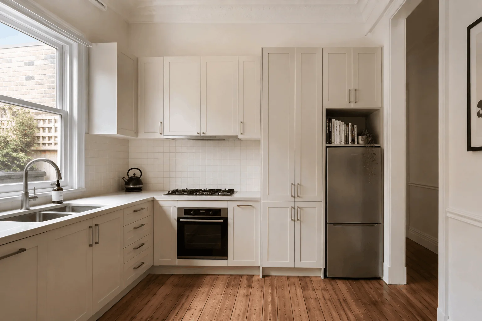 Illustrative custom kitchen cabinetry layout with full-height storage and integrated appliances